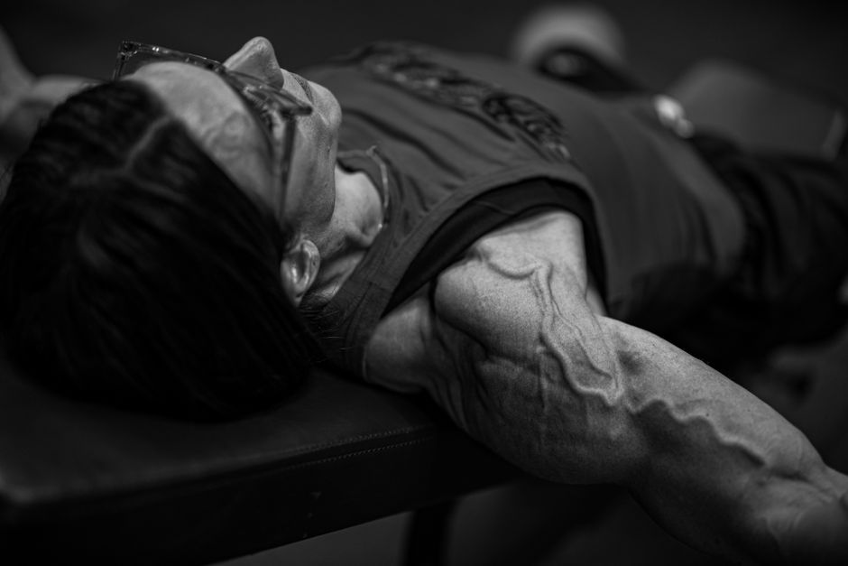 Close-up of muscle definition and sweat during an intense workout.