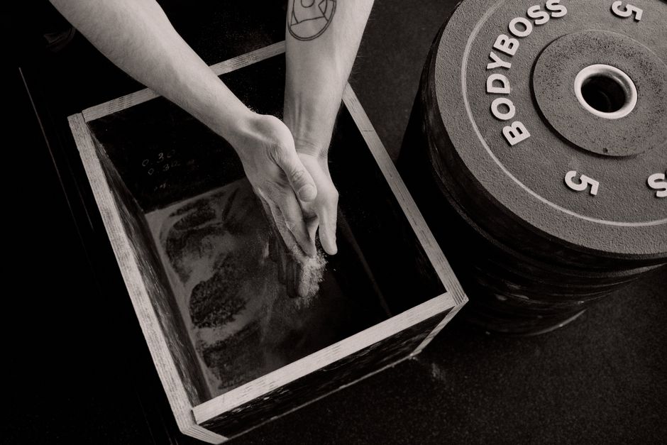 Textured detail of weight plates and chalk at the studio.