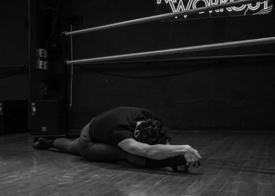 An athlete working on mobility and stretching at the studio.