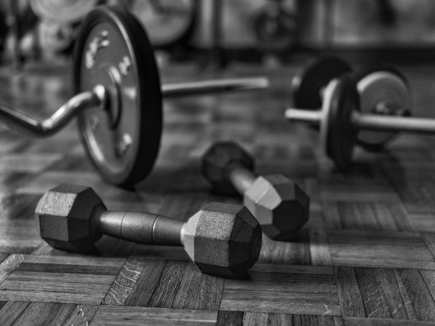 Close-up of stacked iron weight plates at the studio.